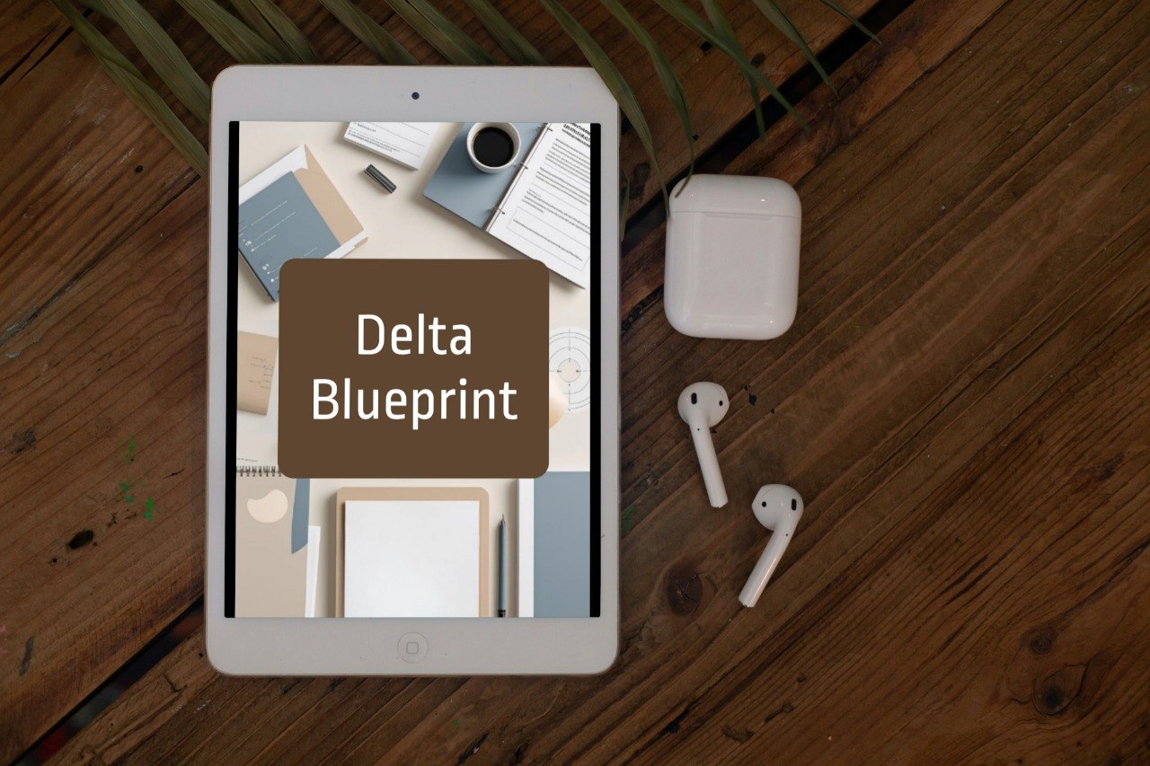 A tablet lying on a wooden tabletop, displaying a mockup with the text 'Delta Blueprint' over a desk scene. White wireless earbuds and a white charging case are placed beside the tablet.